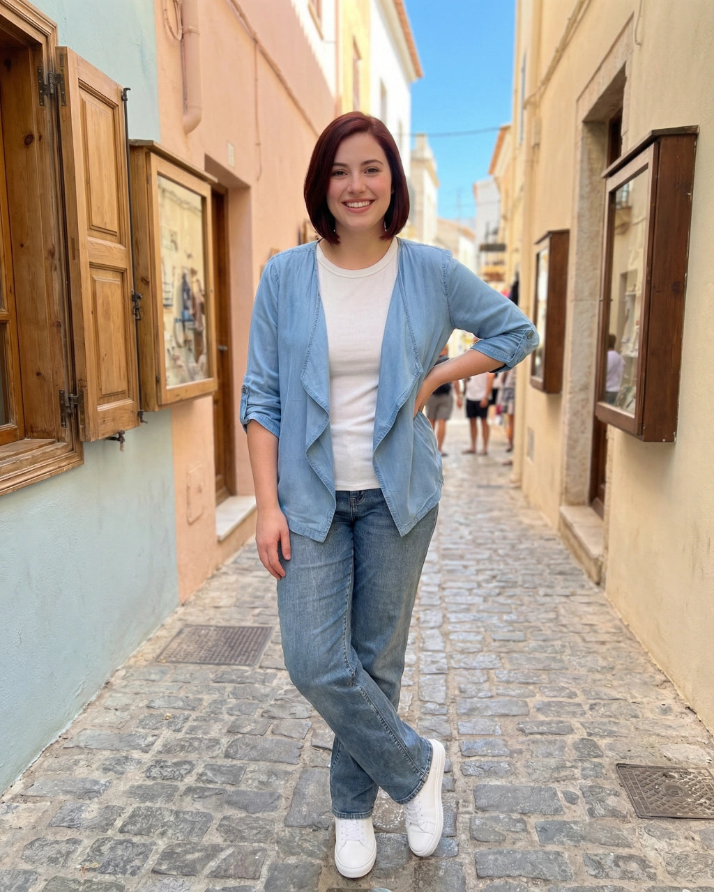 Woman standing on a narrow street with buildings on either side